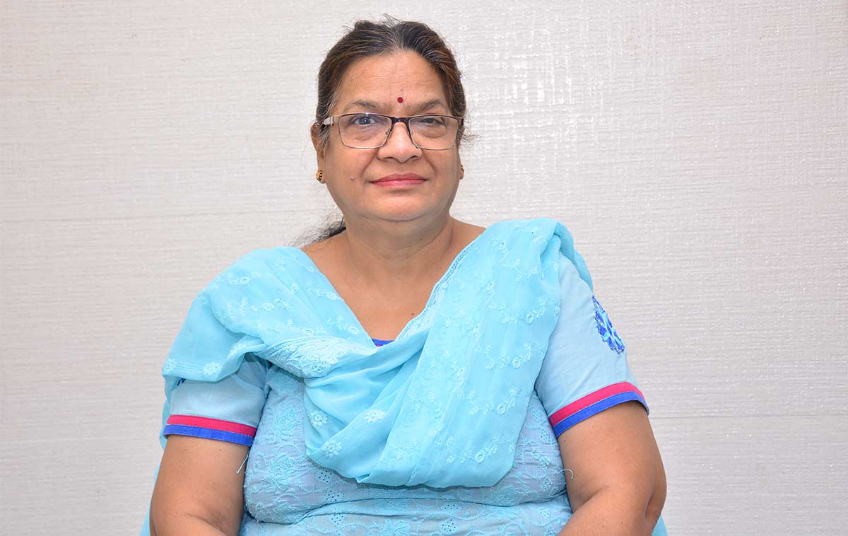Dr. Promila Gupta seated in a blue outfit