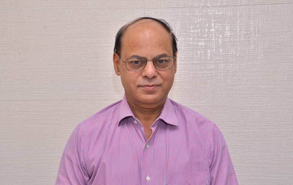 Dr. Rakesh Gupta wearing a purple shirt